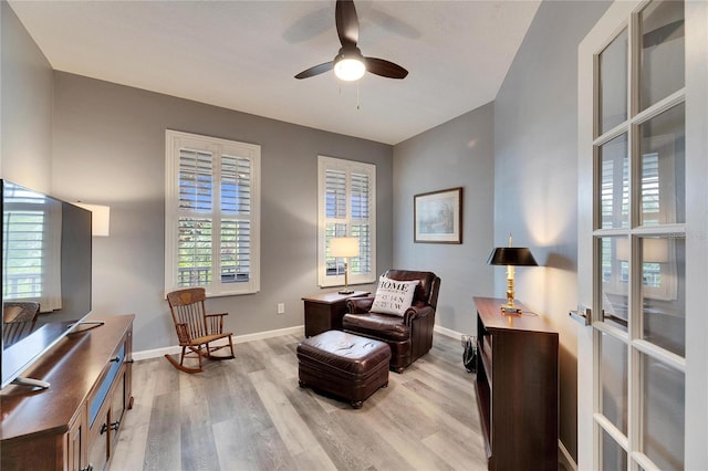 living area featuring ceiling fan, french doors, and light wood-type flooring