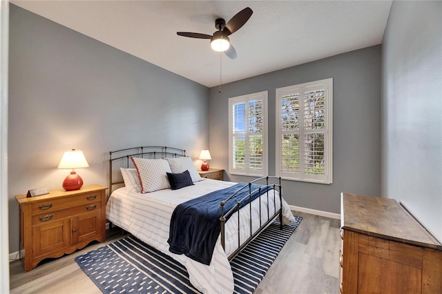 bedroom with ceiling fan and light wood-type flooring