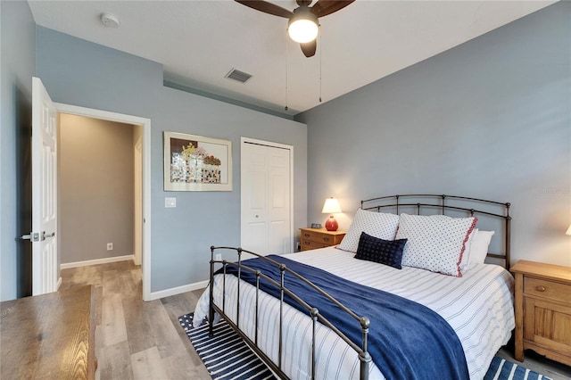 bedroom featuring a closet, light hardwood / wood-style floors, and ceiling fan