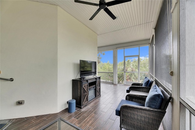 sunroom / solarium featuring ceiling fan