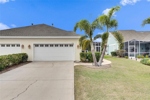 view of front of home featuring glass enclosure, a front lawn, and a garage