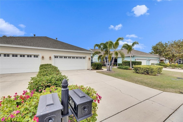 ranch-style home with a front lawn and a garage