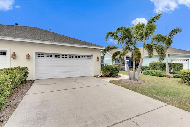 view of front of property featuring a garage and a front lawn