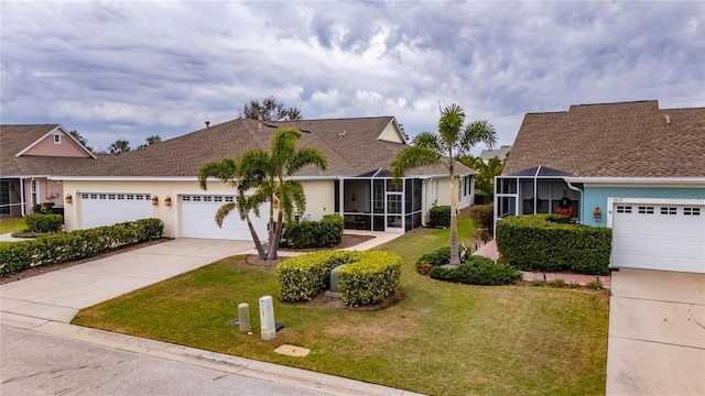 view of front of house with a front yard and a garage