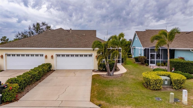 view of front of house with a front yard and a garage