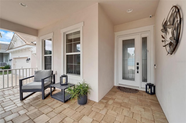 property entrance with a garage and covered porch