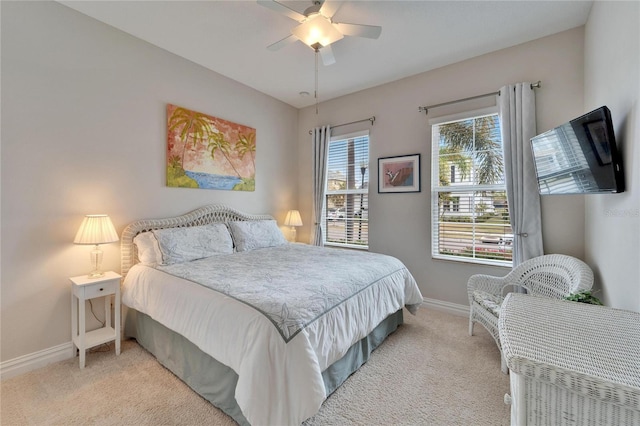 bedroom featuring ceiling fan and light carpet