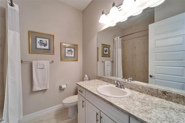 bathroom featuring toilet, walk in shower, and vanity