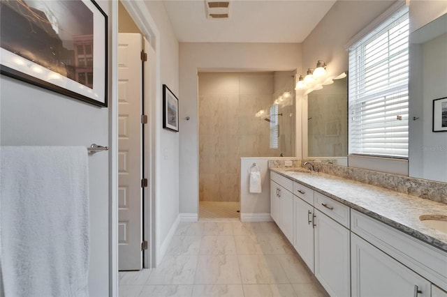 bathroom featuring vanity and a tile shower