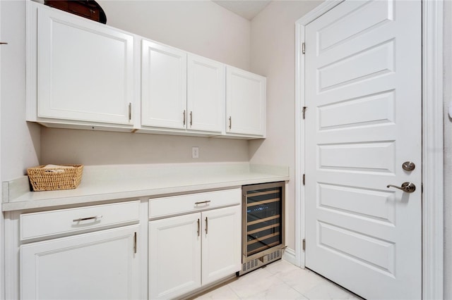 bar featuring white cabinets and beverage cooler