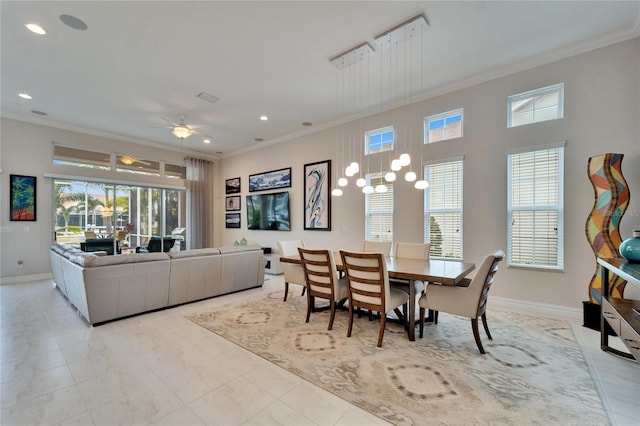 dining space with ceiling fan, a healthy amount of sunlight, and ornamental molding