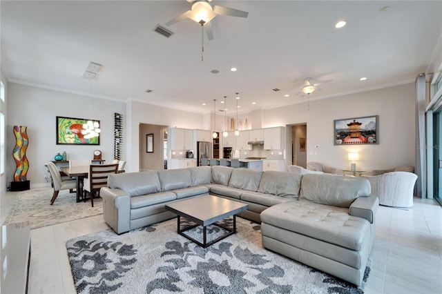 living room with ceiling fan and ornamental molding