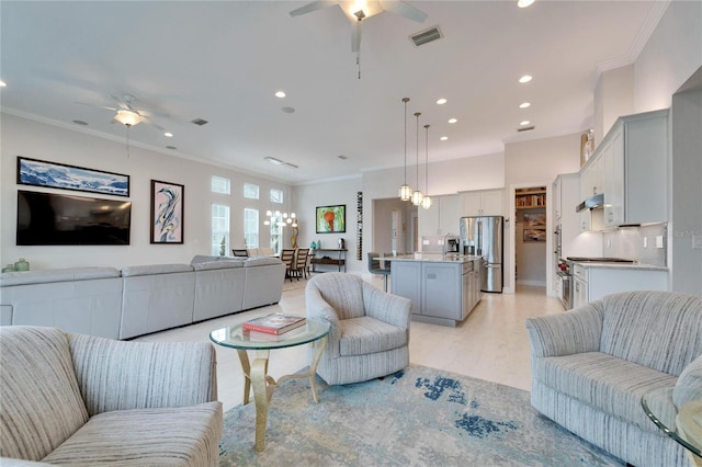 living room with crown molding and ceiling fan with notable chandelier