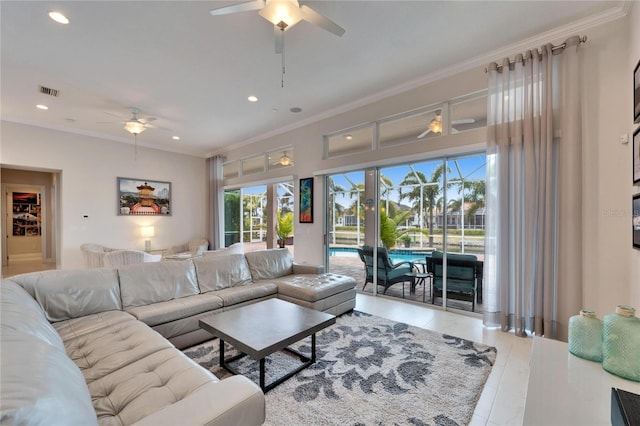 living room featuring ceiling fan, light tile patterned floors, and crown molding