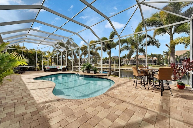 view of pool featuring a lanai, a water view, and a patio