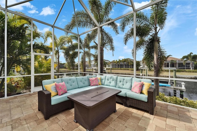 view of patio featuring outdoor lounge area and glass enclosure