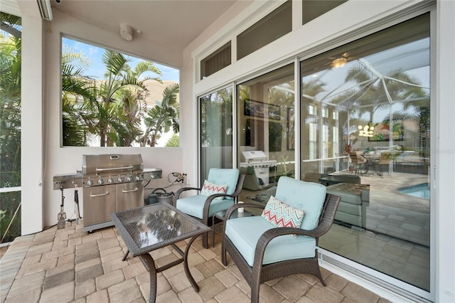 view of patio / terrace featuring glass enclosure and area for grilling