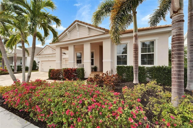 view of front of property featuring covered porch and a garage