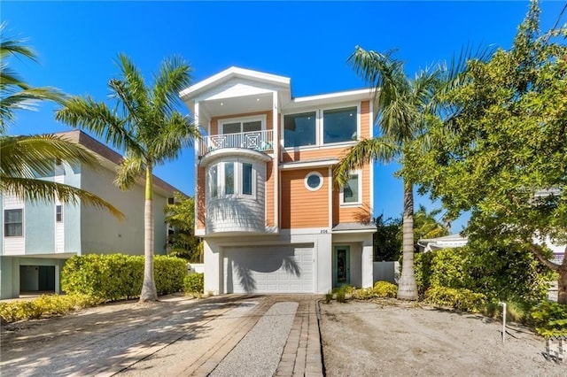 view of front facade featuring a balcony and a garage