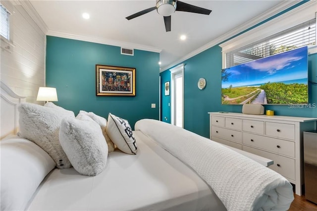 bedroom featuring ceiling fan, hardwood / wood-style floors, and crown molding