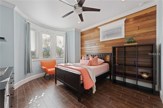 bedroom featuring ceiling fan, dark hardwood / wood-style flooring, crown molding, and wooden walls