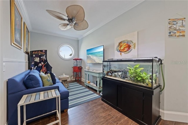 living area featuring ceiling fan and crown molding