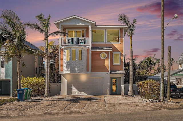 view of front facade with a garage and a balcony