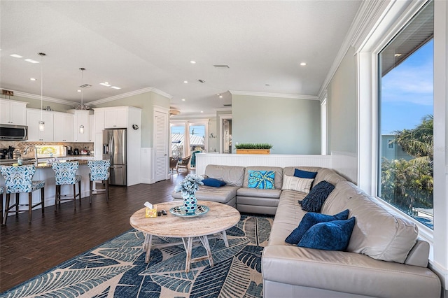 living room featuring crown molding, dark hardwood / wood-style floors, and sink