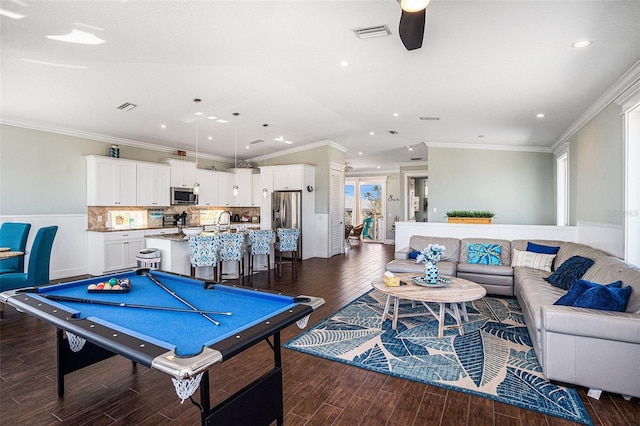 recreation room with vaulted ceiling, dark wood-type flooring, and crown molding