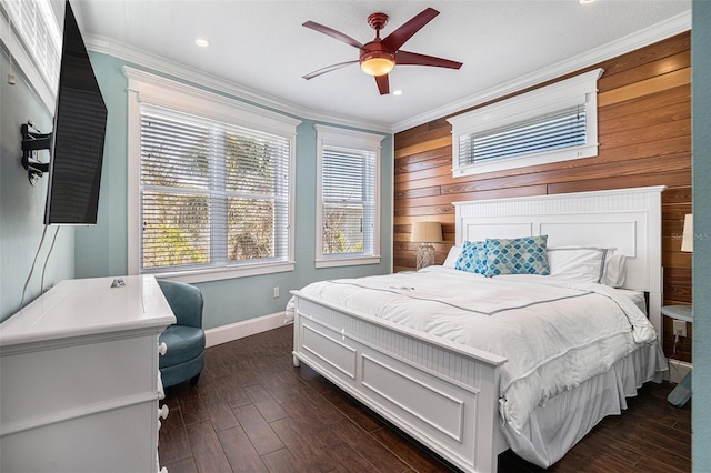 bedroom with dark hardwood / wood-style flooring, wooden walls, ornamental molding, and ceiling fan