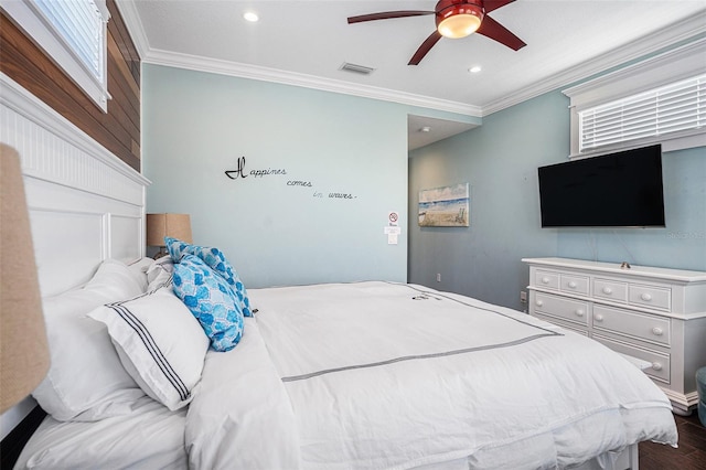 bedroom with wood-type flooring, ornamental molding, and ceiling fan