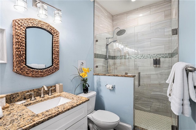 bathroom with vanity, an enclosed shower, and toilet