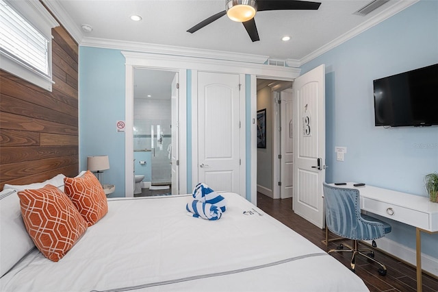 bedroom with dark wood-type flooring, ensuite bathroom, wood walls, crown molding, and ceiling fan