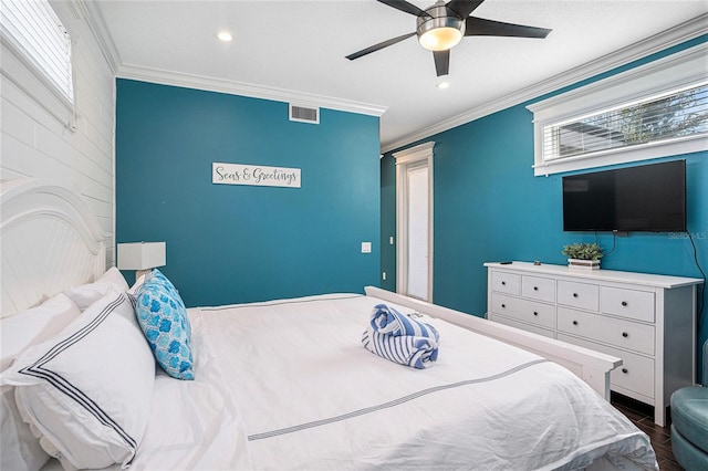 bedroom with ceiling fan, ornamental molding, and hardwood / wood-style floors