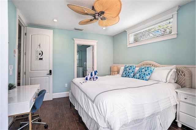 bedroom with ceiling fan, dark hardwood / wood-style flooring, and ensuite bath