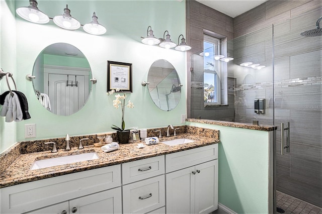 bathroom featuring vanity and a shower with shower door