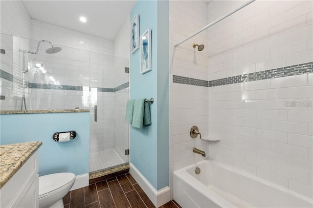 206 Church Ave, Bradenton Beach, FL 34217 - bathroom featuring baseboards, toilet, vanity, wood tiled floor, and tiled shower / bath