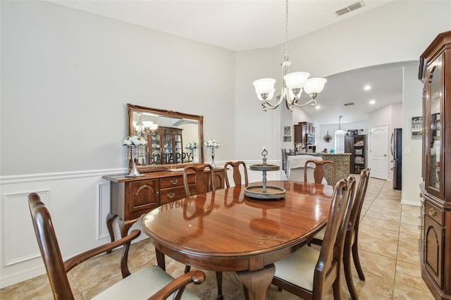 dining space with a chandelier and light tile patterned floors