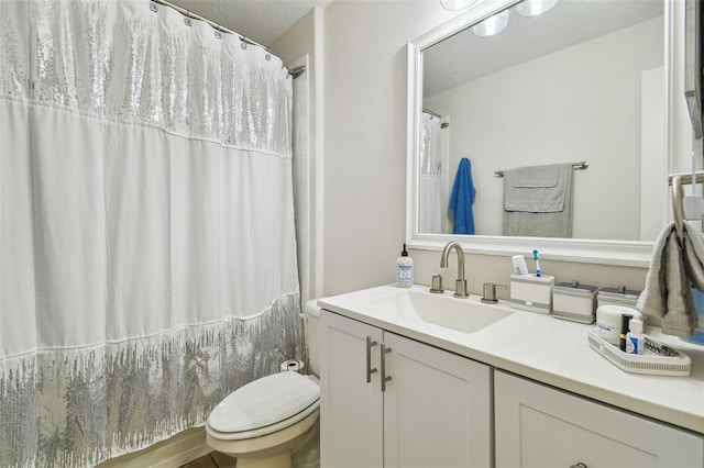 bathroom featuring toilet, vanity, a textured ceiling, and a shower with curtain