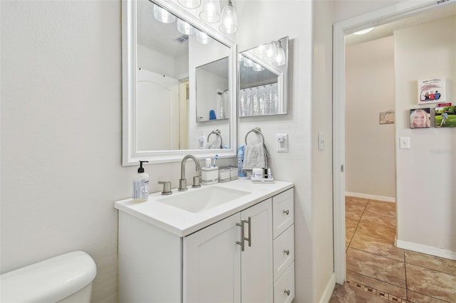 bathroom with toilet and vanity