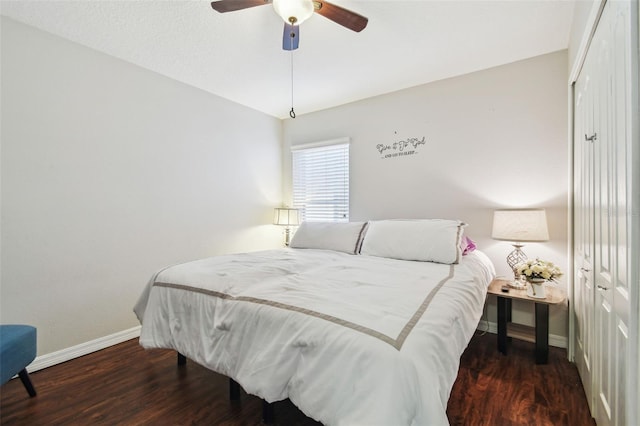 bedroom featuring dark wood-type flooring, ceiling fan, and a closet