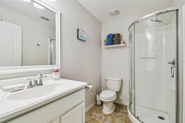 bathroom featuring toilet, a textured ceiling, a shower with door, and vanity