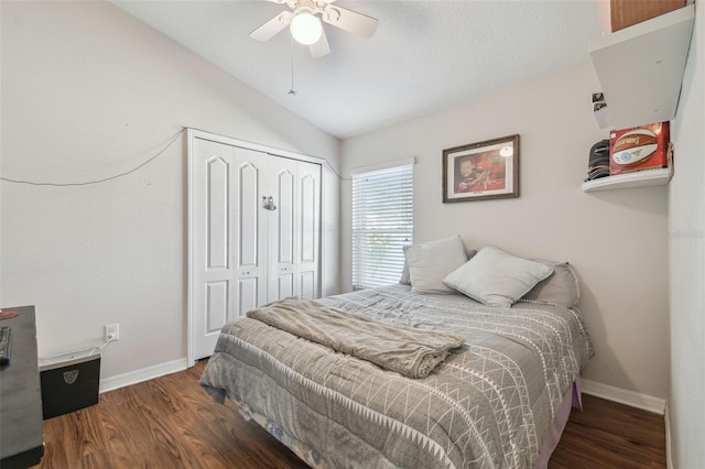 bedroom featuring dark hardwood / wood-style flooring, a closet, ceiling fan, and vaulted ceiling