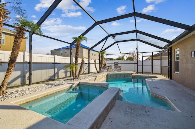 view of swimming pool with a lanai, an in ground hot tub, and a patio