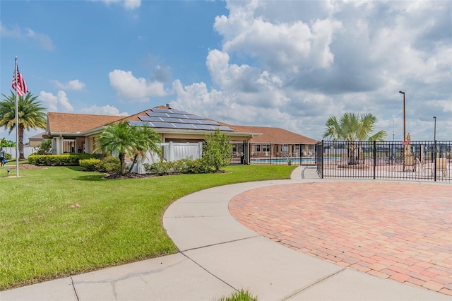 view of home's community featuring a yard and a pool