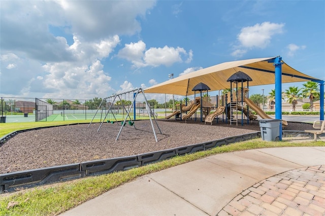 view of jungle gym featuring tennis court