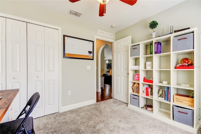 unfurnished office featuring light colored carpet and ceiling fan