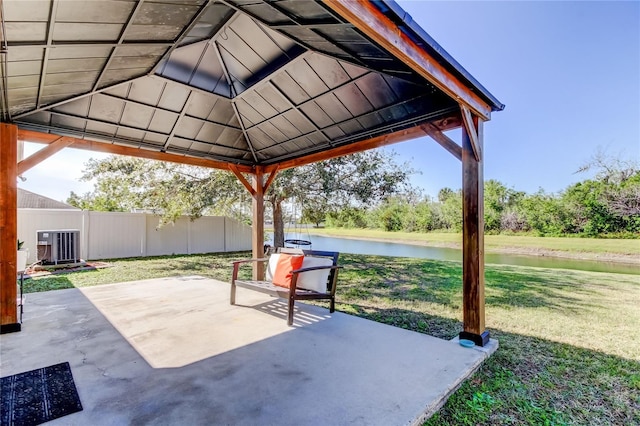 view of patio with a gazebo, central air condition unit, and a water view