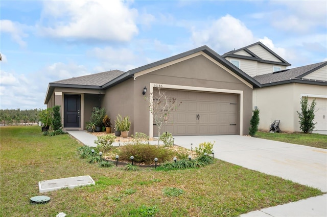 view of front of property featuring a front yard and a garage