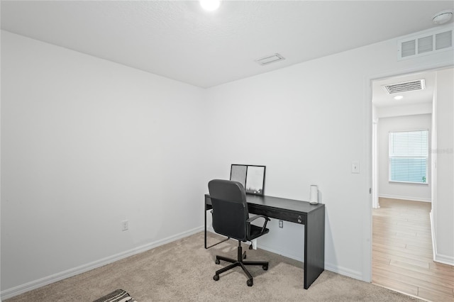 office area with light colored carpet